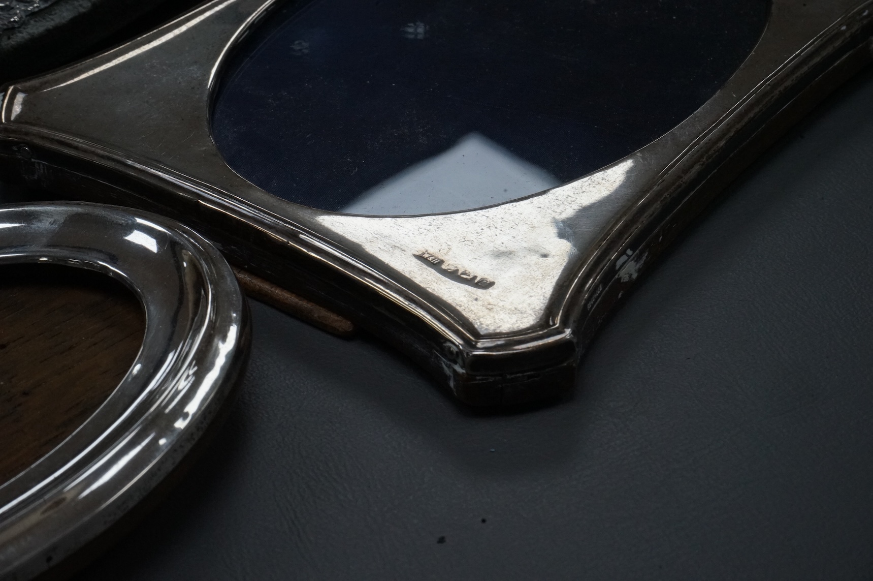 Four assorted early 20th century silver mounted photograph frames, the largest with pierced decoration, Chester, 1902, 19.5cm.